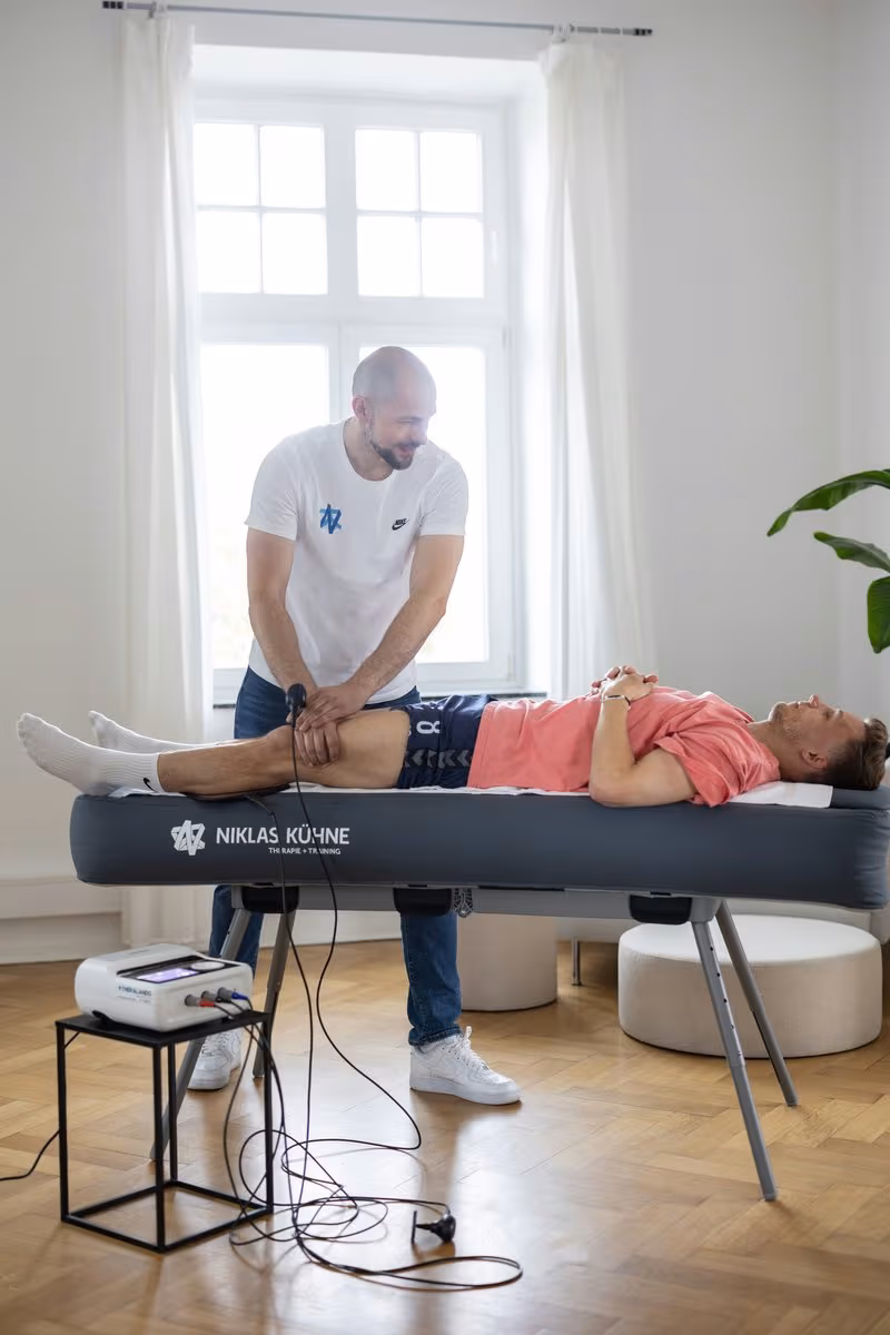 Niklas Kühne behandelt einen Sportler auf der mobilen Behandlungsliege